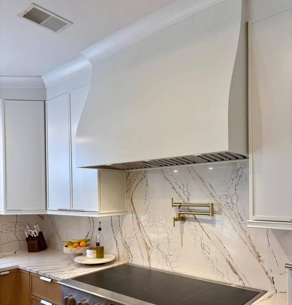 Detail of a professionally finished white hood and crown molding